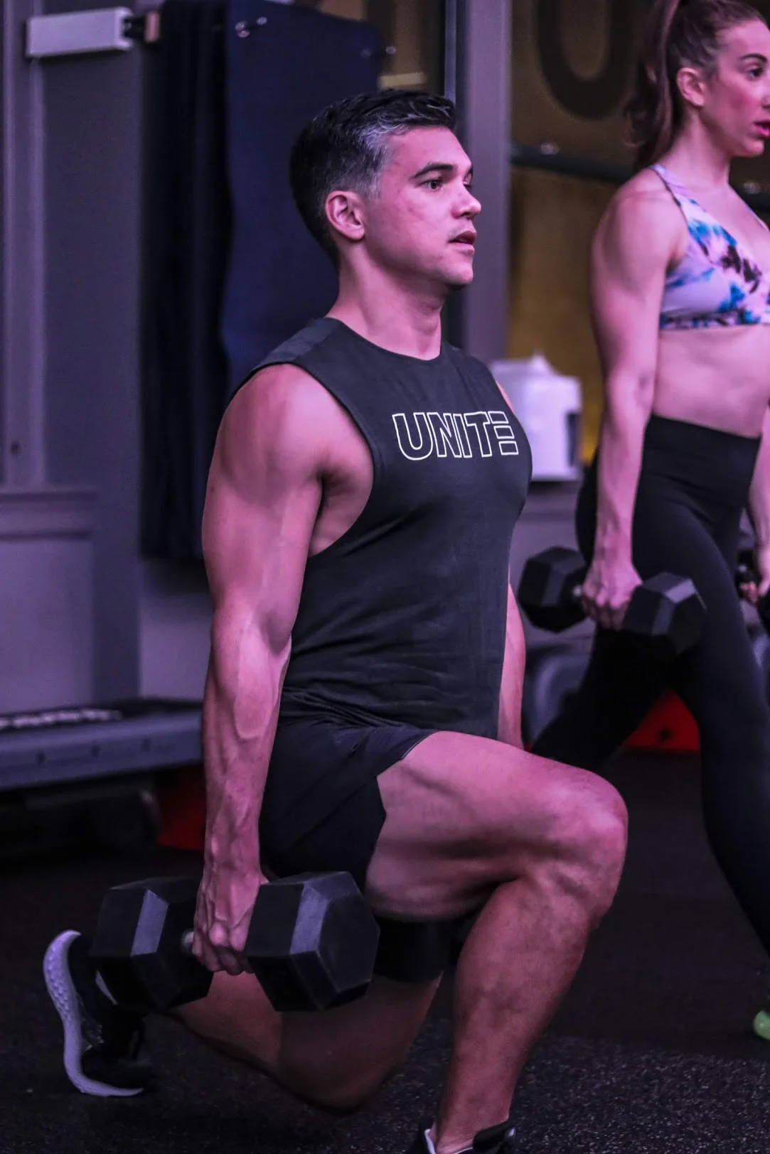 Dumbbell lunges during a gym workout